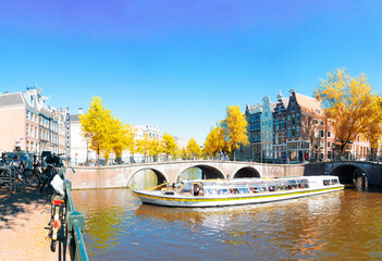 Wall Mural - houses of amsterdam netherlands over canal with boat in old european city, amsterdam spring scenery 