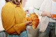 © Franci Leoncio - Close-up of a businesswoman holding a croissant during an office break