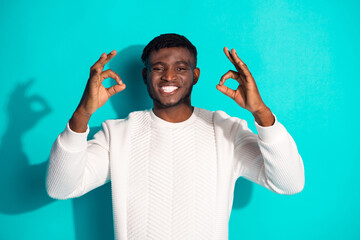 Photo portrait of handsome young guy show okey approve good job dressed stylish white garment isolated on cyan color background