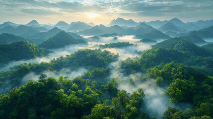 Canvas Print - Misty morning in the mountains, with the sun shining through the clouds.