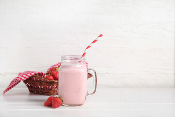 Wall Mural - Mason jar of tasty strawberry smoothie on table