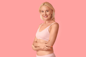 Canvas Print - Beautiful mature happy body positive woman in underwear on pink background