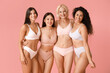 © Pixel-Shot - Beautiful different happy body positive women hugging on pink background