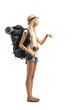 © Ljupco Smokovski - Full length shot of a young female tourist with a backpack pointing