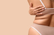 © Pixel-Shot - Beautiful young African-American body positive woman on beige background, back view