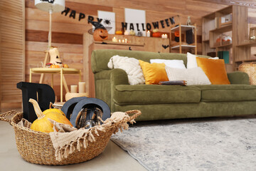 Canvas Print - Basket with Halloween pumpkins and decor in living room, closeup