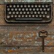 © BOJOShop - Vintage Typewriter on Rustic Wooden Background with Key