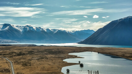 The way to Lake Ohau and the southern alps through alpine grasses and tundra terrain