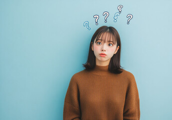 Poster - A young Japanese woman in a blue blouse is thinking with a question mark on a white background