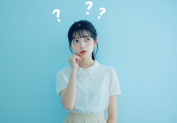 Poster - A young Japanese woman in a blue blouse is thinking with a question mark on a white background