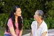 © wavebreak3 - Talking and smiling, granddaughter and asian grandmother enjoying conversation outdoors