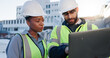 © WesLens/peopleimages.com - Team, tech or planning construction on rooftop for building maintenance, civil engineer or discussion. Contractors, laptop or project management in city with architect for infrastructure development