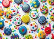 © kittipon - bright playful colorful pin-back buttons and confetti scattered on white background with bold graphic shapes and crisp clean lines