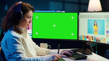 Poster - photo editor using green screen monitor to color correct photographs in creative studio, listening m