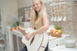 © ultramansk - A musician woman plays an acoustic guitar in a bright kitchen, combining the themes of domestic life and artistic expression, reflecting a relaxed lifestyle focused on creativity and comfort.