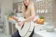 © ultramansk - A musician woman plays an acoustic guitar in a bright kitchen, combining the themes of domestic life and artistic expression, reflecting a relaxed lifestyle focused on creativity and comfort.