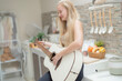 © ultramansk - A musician woman plays an acoustic guitar in a bright kitchen, combining the themes of domestic life and artistic expression, reflecting a relaxed lifestyle focused on creativity and comfort.