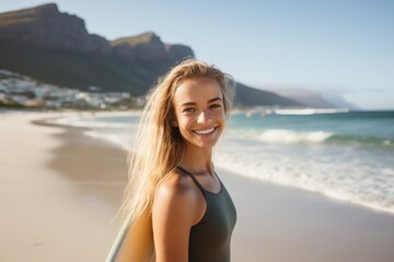 Wall Mural - Portrait of a young Caucasian female surfer on the beach