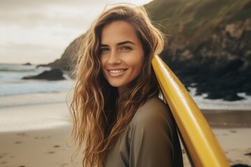 Wall Mural - Portrait of a young Caucasian female surfer on the beach