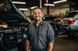 © Baba Images - Portrait of a middle aged male car mechanic in workshop