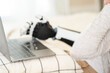 © ultramansk - A young woman is using a robotic prosthetic arm hand attached to her body to work on a desk. she is doing computer document and communication work. woman tries to control the smart arm in her home.