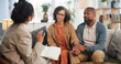 © WesLens/peopleimages.com - Couple, therapy and holding hands with discussion on sofa for guidance, communication and advice. Consultation, service and therapist with book in office for marriage counseling, support and progress