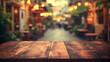© Siasart Studio - Close up of wooden table top with a blurred background of a restaurant patio at night.
