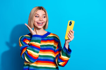 Canvas Print - Photo of nice young woman use phone empty space wear striped sweater isolated on blue color background