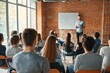© 为轩 张 - Group of young people seated in chairs, attentively listening to a speaker presenting information on a whiteboard. The scene captures a bright, airy room with brick walls and natural light streaming t
