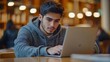 © Generative AI - Latin American male student using laptop focused on working on a diploma project making researches on internet studying online in a modern innovation library campus People Erudition Ed : Generative AI