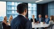© VistaVisions - Confident businessman giving a presentation in front of crowd in meeting conference seminar room. Leadership authority teamwork in business concept