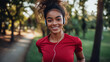 © Click It - Stylish young female in a red t-shirt and white earphones running on the path in the park