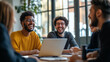 © Click It - diverse group of people are laughing and working together in an office meeting room with a laptop on the table