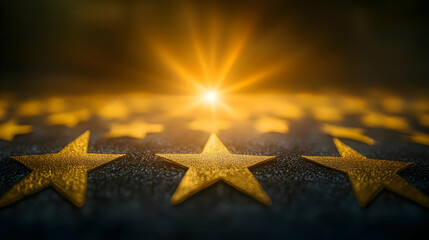 Poster - A close-up of golden stars with a radiant light in the background.