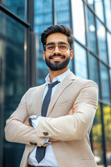 Wall Mural - young indian businessman standing near office building