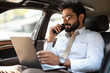 © Niks Ads - young indian businessman working on laptop in car