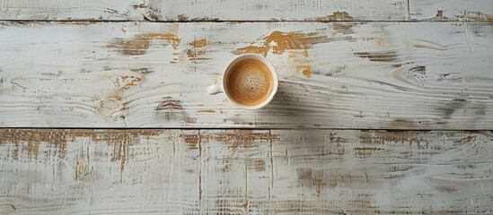 Cup of coffee on a white wooden surface Copy space on the wood