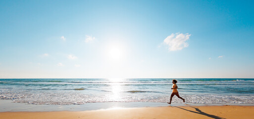 Active man jogging. Healthy lifestyle. a man runs barefoot along the beach by the sea. A young runner runs along an empty beach at dawn.