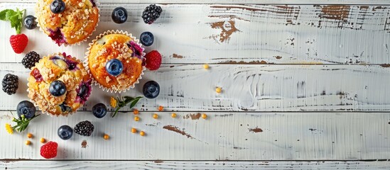 Poster - Lemon muffins with blueberries and streusel topped with fresh berries placed on a white wooden background A delightful breakfast Copy space