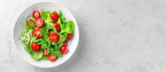 Wall Mural - Green salad with tomatoes and fresh vegetables in a white bowl on a grey background Top view. Copy space image. Place for adding text and design