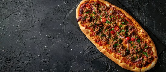 Wall Mural - Sucuklu Pide Turkish Sausage pizza on a dark black stone table background top view flat lay with copy space for text