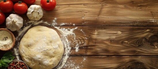 Wall Mural - Raw dough with pizza ingredients on a wooden table with space for text. Copy space image. Place for adding text and design