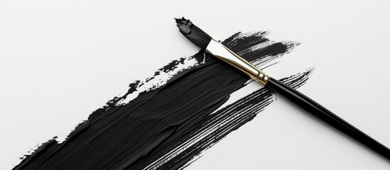 Poster - Black paint and a paintbrush on a white paper background. Copy space image. Place for adding text and design