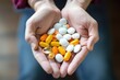 © photolas - Multi-colored tablets, pills and capsules in the hands.
