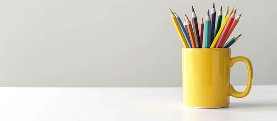 Poster - Colored pencils and a portion of a mug on a white background Copy space