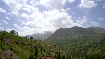 Wall Mural - A mountain range with a clear blue sky and a few clouds