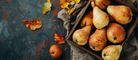 Wall Mural - Pears Fresh sweet organic pears with leaves in a wooden box or basket on an old stone tile backdrop Framed by autumn harvest fruits Top view Food background Mock up. Copy space image