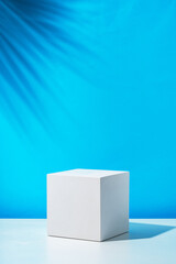 Poster - A clean white cube positioned on a minimalist surface against a vibrant blue backdrop