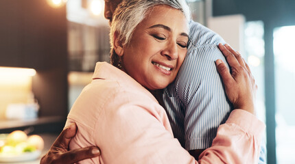 Wall Mural - Home, senior couple and love with hug for connection, security and bonding together in kitchen. Interracial marriage, woman and man with embrace for relationship, commitment and support in house