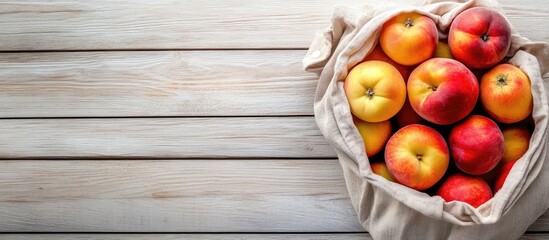 Aufkleber - Eco friendly packaging zero waste for plastic shopping A lifestyle concept using recycled materials Fresh apples and peaches in a cloth bag Wooden boards backdrop copy space top view